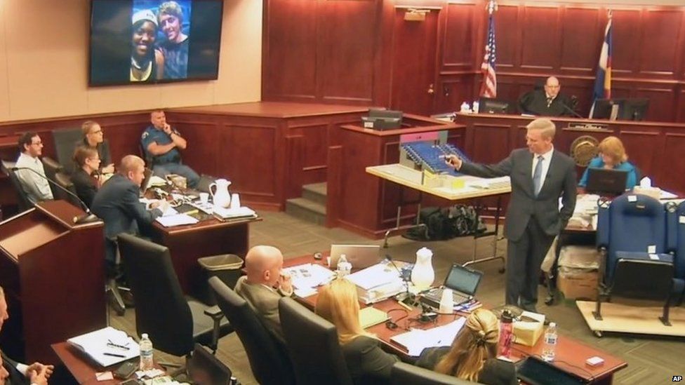 Image taken from video showing James Holmes, left, listening to lead prosecutor George Brauchler