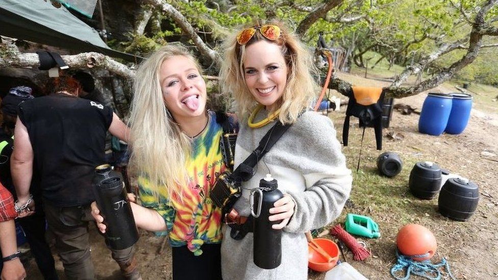 Two of the people from Eden, sticking their tongues out
