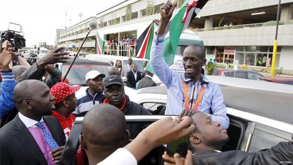 IAAF men's 3000 metres steeplechase gold medallist Kemboi greets his supporters at the Jomo Kenyatta airport Nairobi, Kenya
