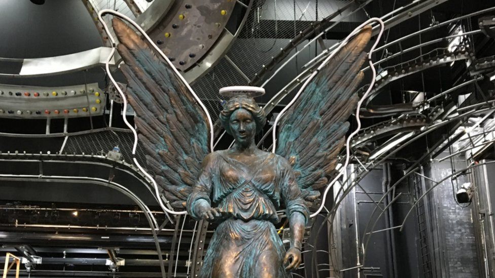 An angel with neon wings is one of the most important props