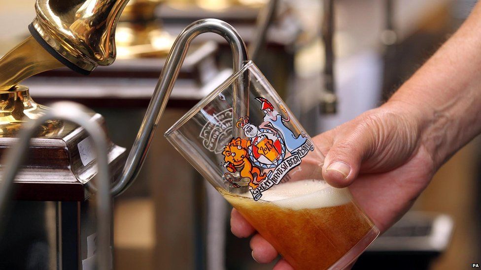 Someone pouring a pint