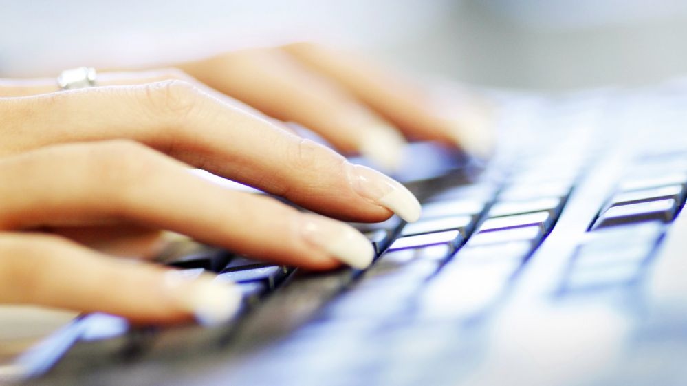 Hands on a computer keyboard