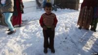 A Syrian child stands in the snow in a refugee camp in the Beqaa Valley, Lebanon. Photo: 12 December 2013