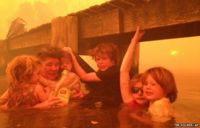 For three hours, Tim Holmes and his family sought refuge in neck-deep water under a jetty near the town of Dunalley.