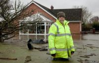 5. A Moorland villager clears debris in his front garden