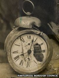 Alarm clock with shell fragment embedded in the workings.