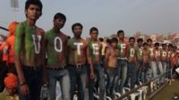 Supporters of India"s opposition Bharatiya Janata Party (BJP)"s prime ministerial candidate Narendra Modi stand with their bodies painted at a youth convention in Ahmadabad, India.