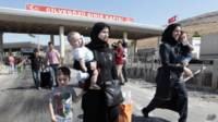 Refugiados sirios cruzando la frontera con Turquía