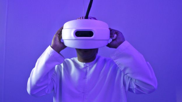 An Emirati man watches through a special viewfinder at the Museum of the future 