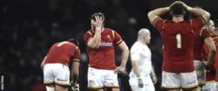 Wales fly-half Dan Biggar (centre) and team-mates stand dejected