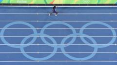 USA's Morolake Akinosun competes in the women's 4 x 100m re-run