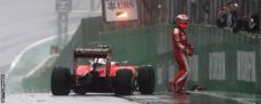 Raikkonen climbs out of his car after a crash
