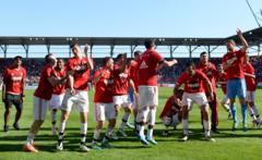 Bayern Munich players celebrate winning the Bundesliga for a record fourth successive season