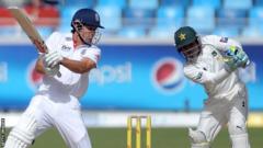England's Alastair Cook and Pakistan's Adnan Akmal in 2012