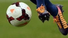 feet in mid air about to kick a football