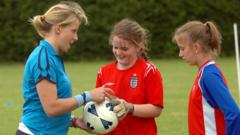 Coach with two young footballers