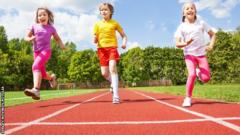 children running on athletics track