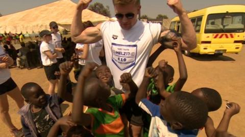 Adam Peaty with children in Zambia