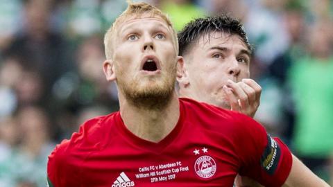 Aberdeen's Jayden Stockley clashes with Celtic's Kieran Tierney