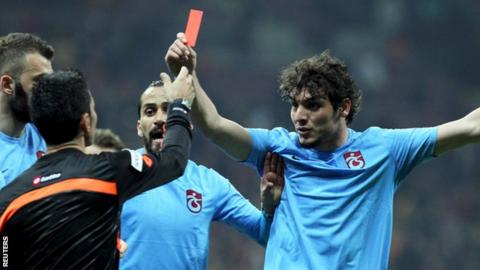 Salih Dursun (right) waves a red card at referee Deniz Bitnel
