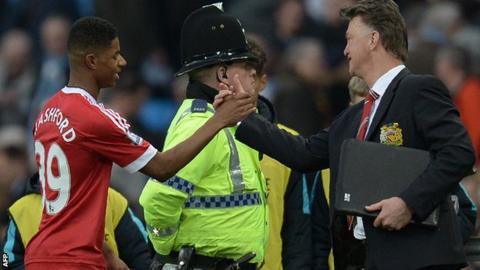 Marcus Rashford shakes hands with Louis van Gaal