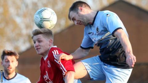 Ballyclare goal-scorer Corey McMullan and Institute's Niall Grace in aerial action at Dixon Park