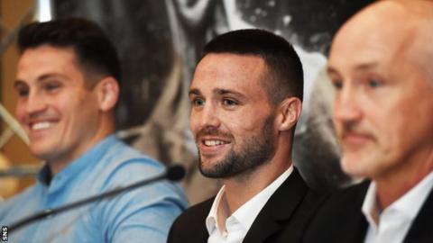 Josh Taylor (centre) is flanked by Shane McGuigan (left) and Barry McGuigan (right)