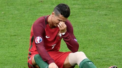 Real Madrid and Portugal forward Cristiano Ronaldo reacts after being injured in the Euro 2016 final
