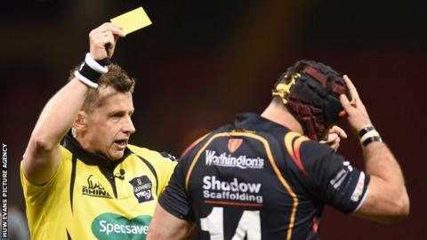 Referee Nigel Owens shows a yellow card during an Ospreys game