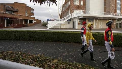 Jockeys at Kempton Park racecourse in Surrey