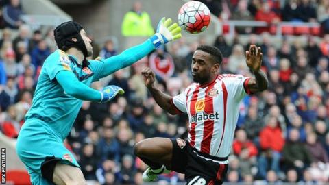 Jermain Defoe challenges in the air with Petr Cech