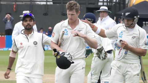 New Zealand's Jimmy Neesham is congratulated by team-mate Neil Wagner and India's Mohammed Shami