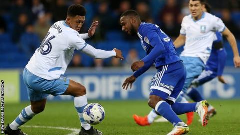 Junior Hoilett of Cardiff City is challenged by Sheffield Wednesday's Liam Palmer