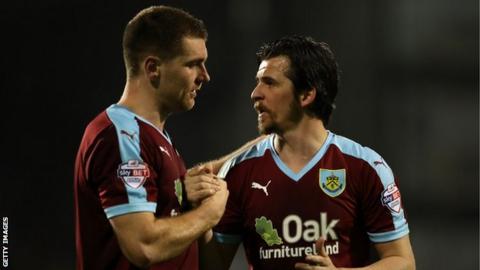Sam Vokes and Joey Barton embrace while with Burnley