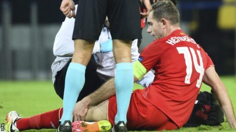 Jordan Henderson sits on the pitch after being injured