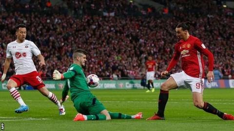 Southampton keeper Fraser Forster denies Manchester United striker Zlatan Ibrahimovic during the EFL Cup final at Wembley