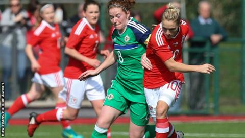 Wales' Jess Fishlock of Wales holds off Marissa Callaghan of Northern Ireland