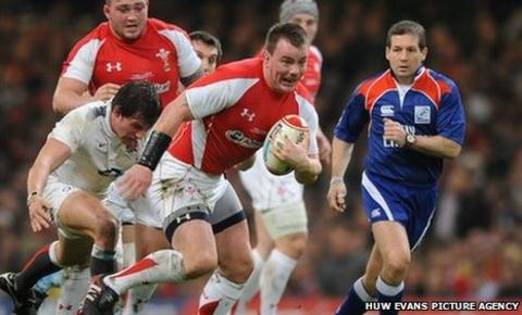 Matthew Rees gets away from Tom Wood of England during the Six Nations