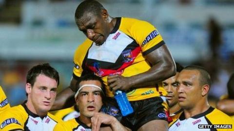 Stanley Gene is carried from the field after his final appearance for Papua New Guinea following their elimination from the 2008 World Cup