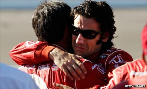 Dario Franchitti hugs a crew member on hearing of Dan Wheldon's death