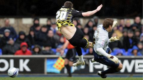 Joe Mason of Cardiff City is fouled by Ipswich goalkeeper Arran Lee-Barrett