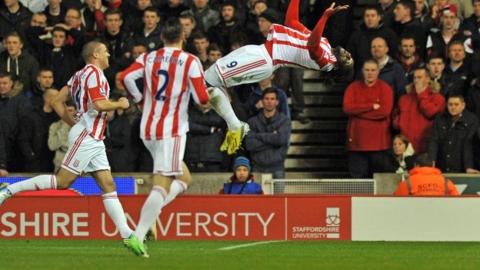 Stoke City's Trinidadian striker Kenwyne Jones (right) celebrates scoring their second goal as teammates US defender Geoff Cameron (second left) and Irish striker Jonathan Walters (left) join in