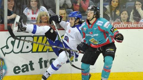 Daryl Lloyd puts in a big hit on Benn Olson in Saturday's game at the Odyssey Arena