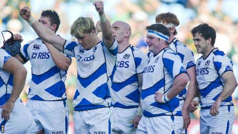 Exhausted Scotland players celebrate their 30-29 win over Italy
