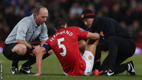 Manchester United defender Rio Ferdinand receives treatment during the defeat by Swansea