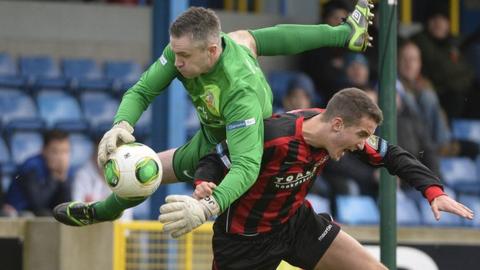 John Connolly beats Crusaders player Josh Robinson to the ball