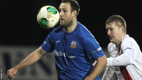 Glenavon striker Guy Bates shields the ball from David Armstrong