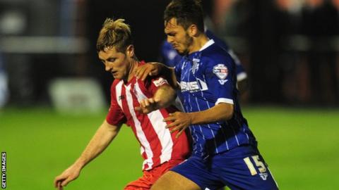 Gillingham's Bradley Dack (r) and Gary Mulligan of Brackley Town