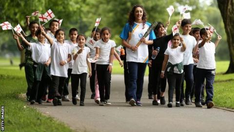 Mimi Cesar carries the Queen's Baton through Ward End Park, Birmingham, June 2014
