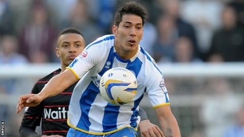 Brighton & Hove Albion's Leonardo Ulloa chests the ball under pressure from Reading's Michael Hector